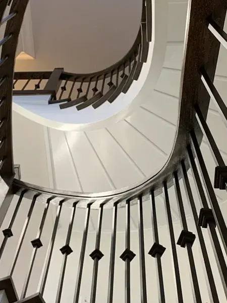 Traditional wood banister and iron picket installation for a staircase renovation in Ancaster