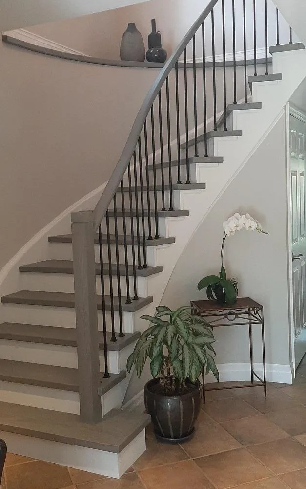 Curved staircase recapped in grey hardwood — modern stair renovation design in the GTA by StairSteps