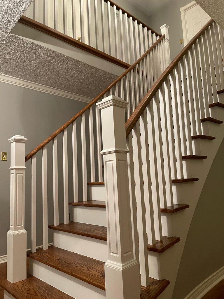 Stunning staircase refinishing project with white accents