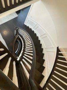Double spiral staircase with modern white spindes in North York